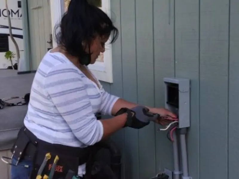 Licensed electrician wiring an exterior subpanel in Joshua Tree